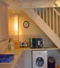 Fowey Cottage Kitchen: washer and microwave